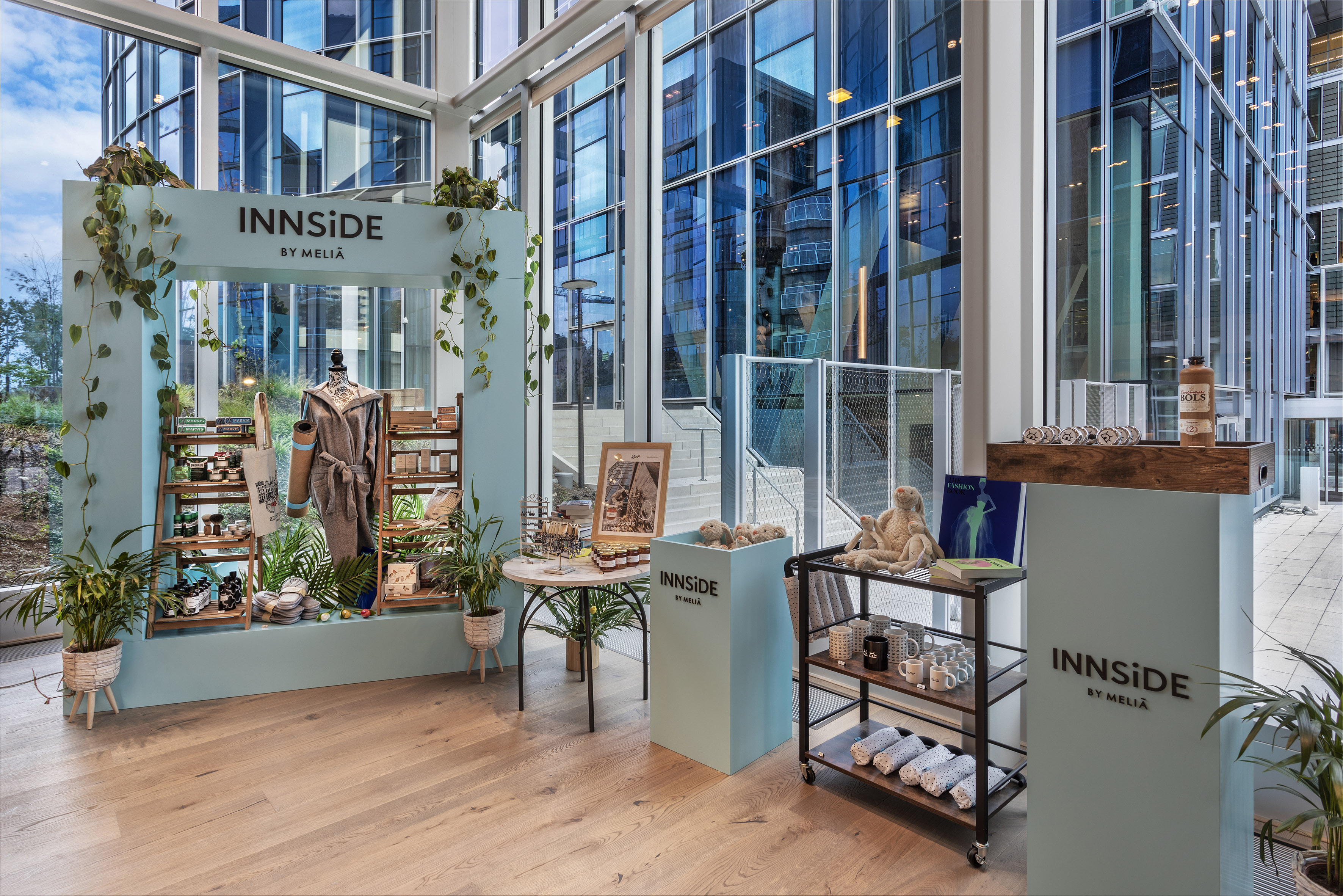 INNSiDE by Meliã retail display with products and plants in a glass lobby.