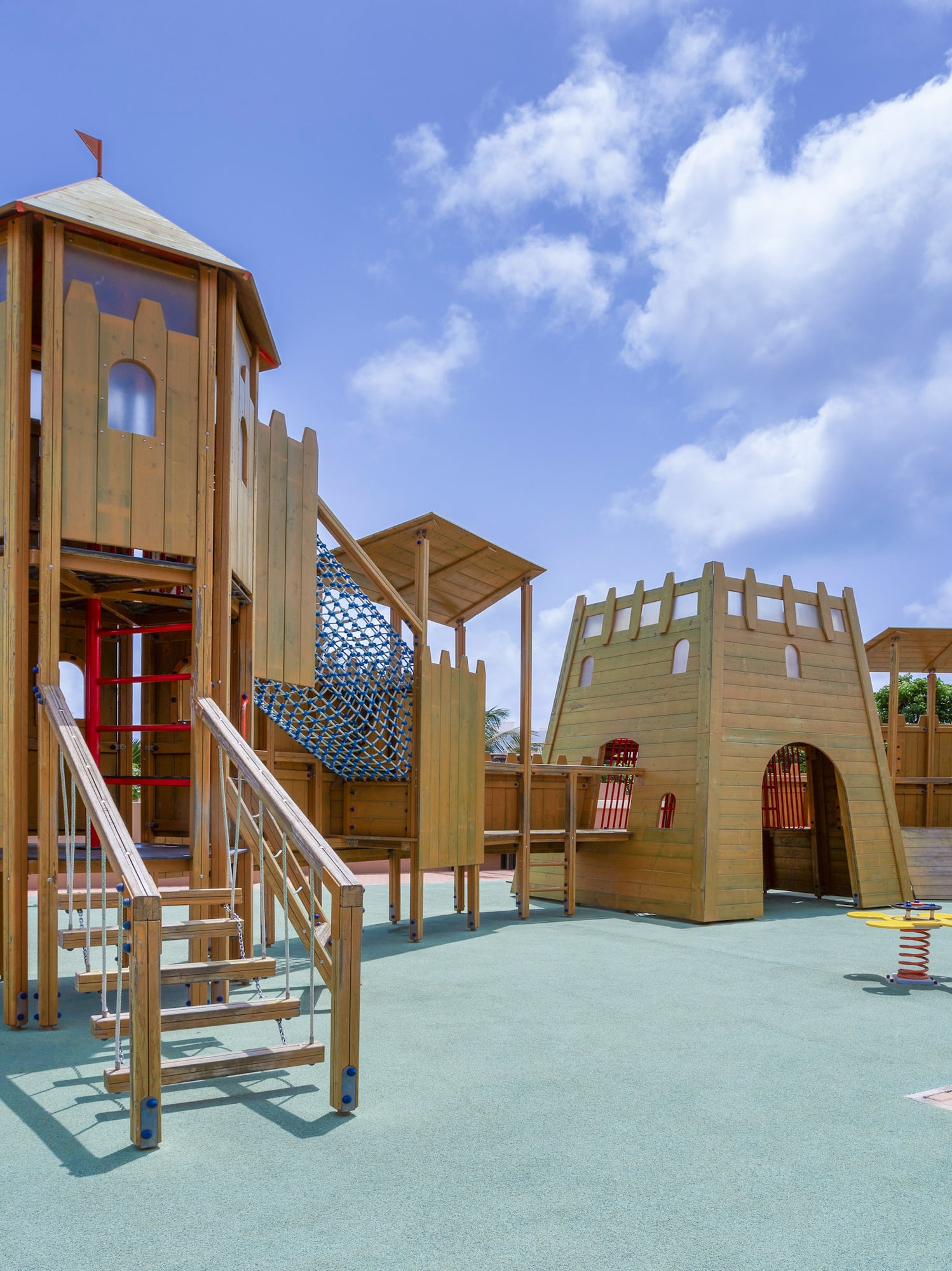 a playground with a slide and a red tube
