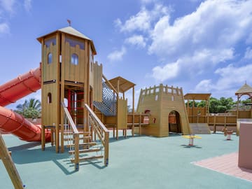 a playground with a slide and a red tube