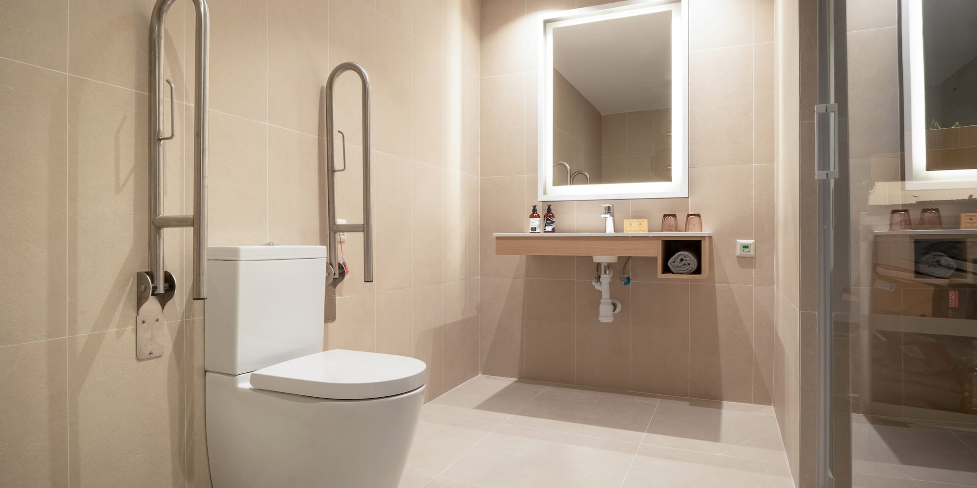 a bathroom with a toilet and a mirror