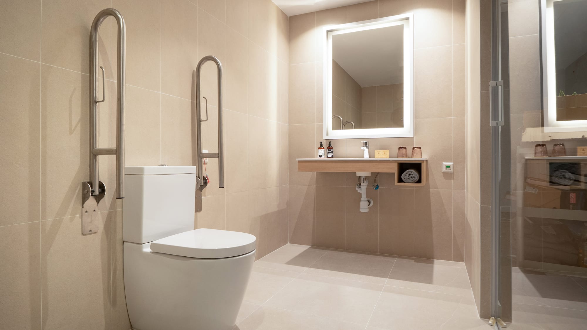 a bathroom with a toilet and a mirror