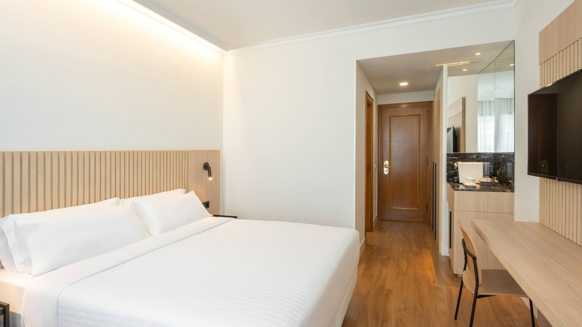 a room with a bed and a wood floor