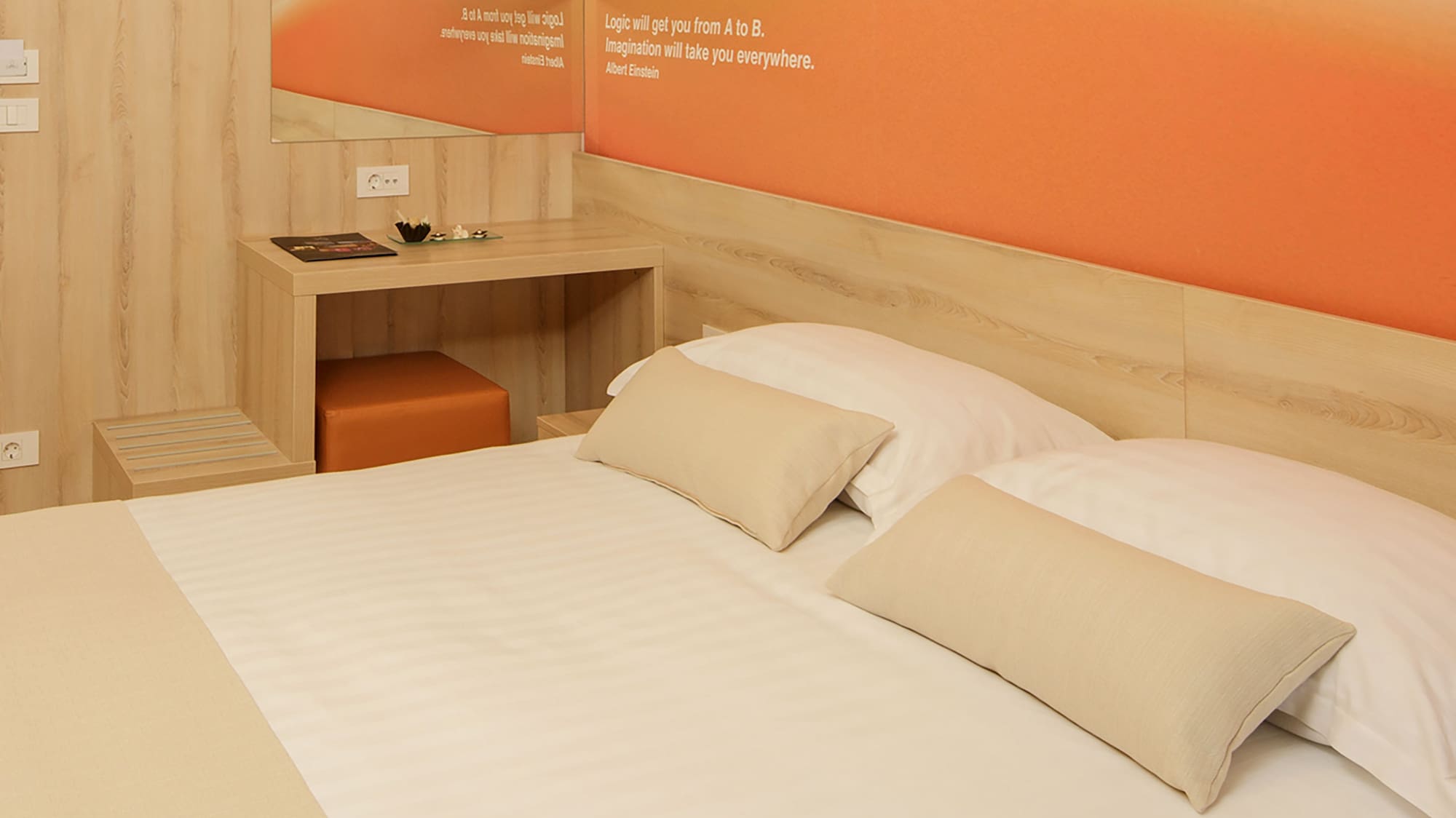 a bed with pillows and a table in a room