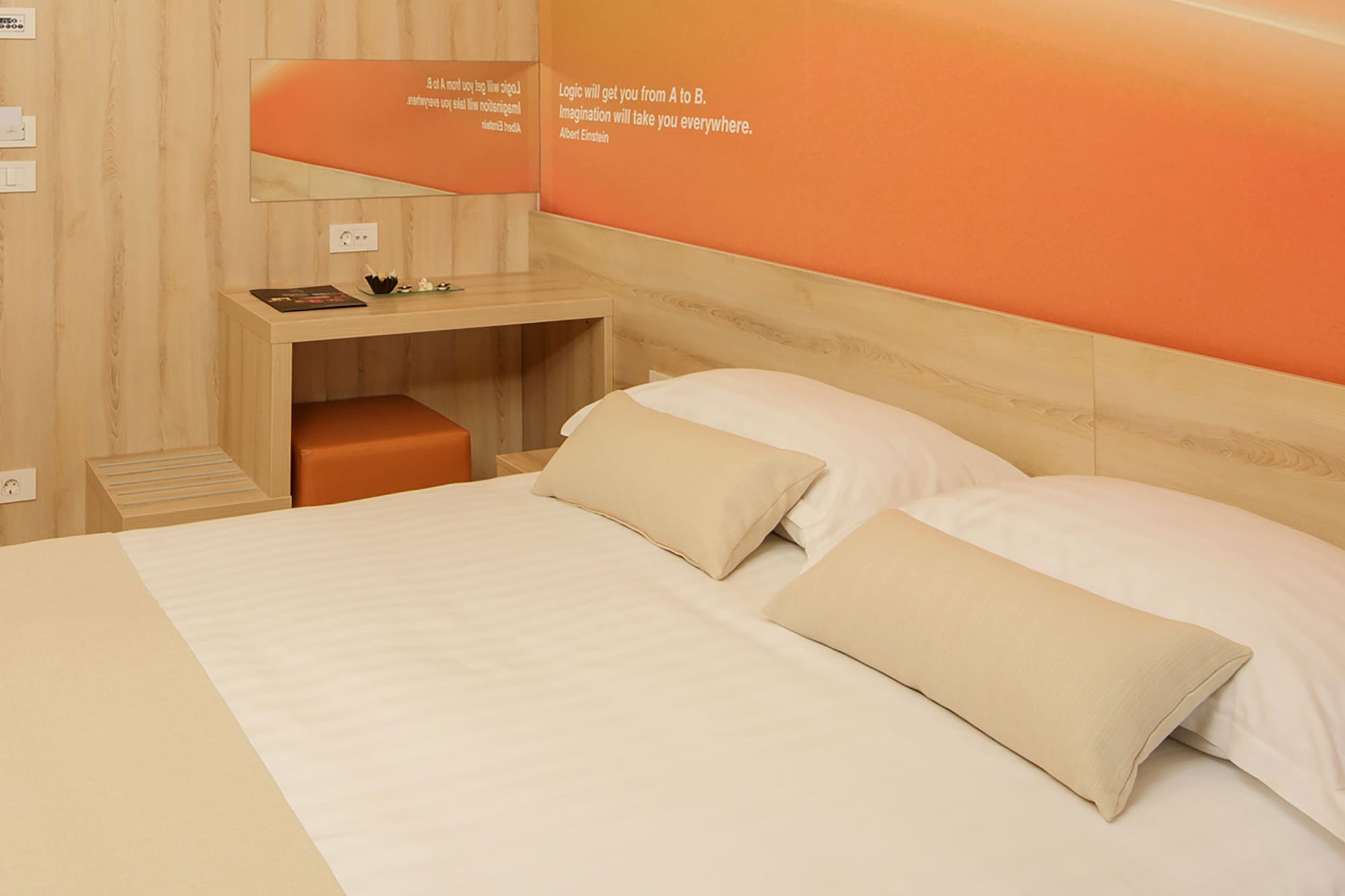 a bed with pillows and a table in a room