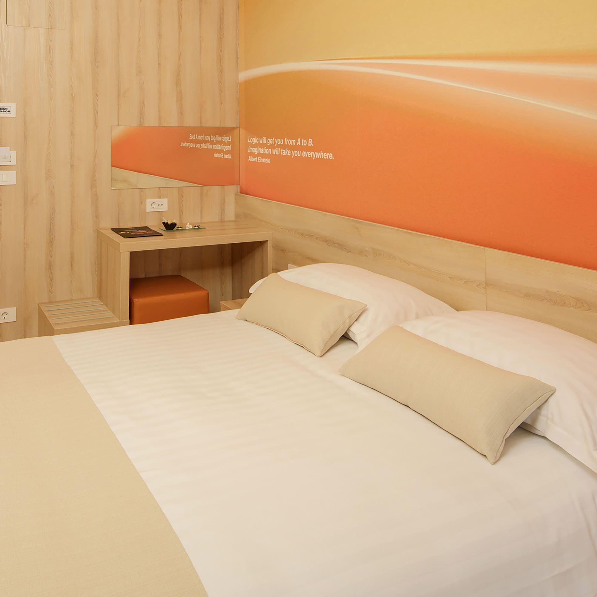 a bed with pillows and a table in a room