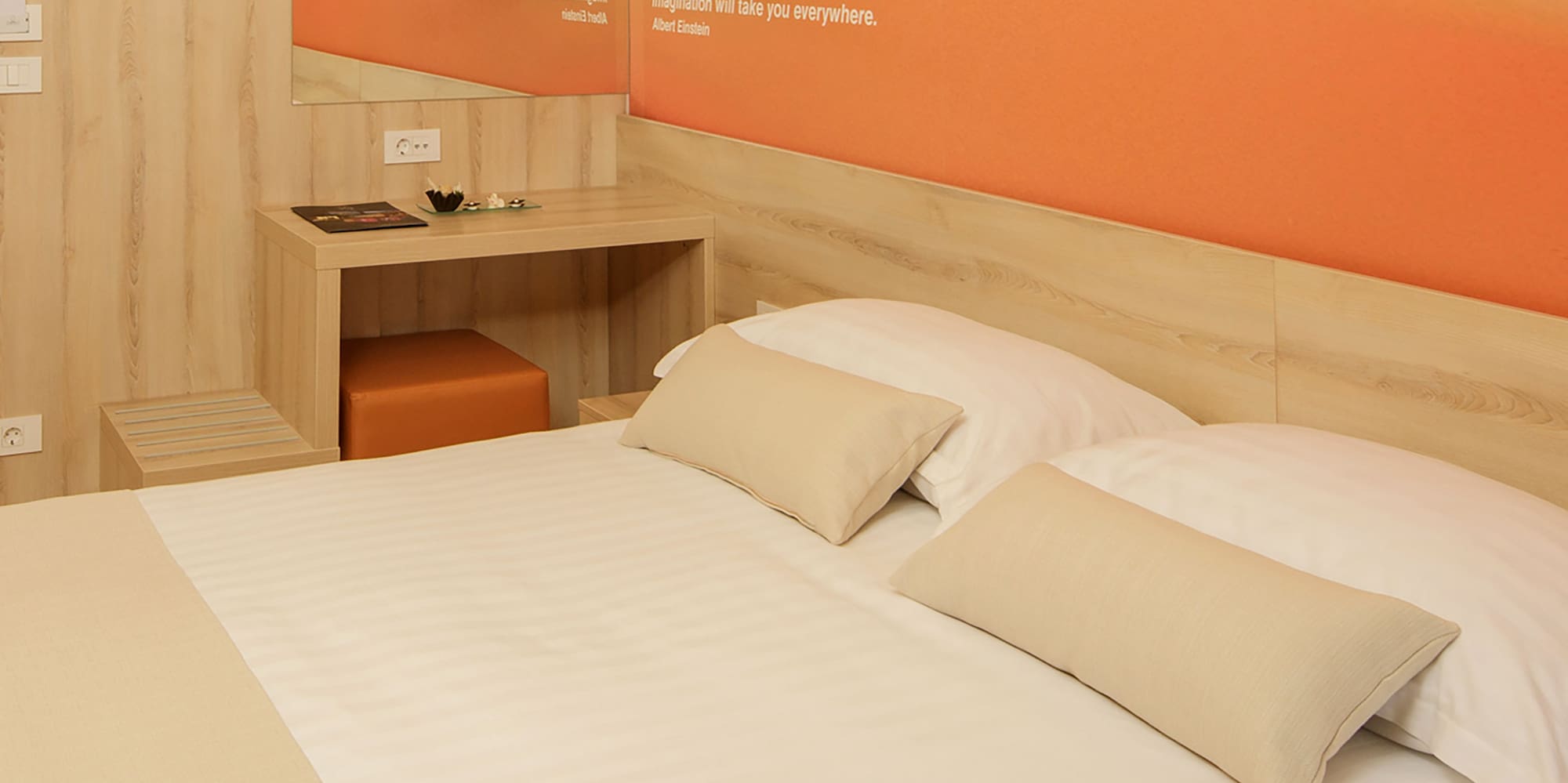 a bed with pillows and a table in a room