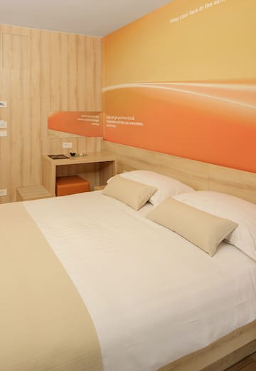 a bed with pillows and a table in a room