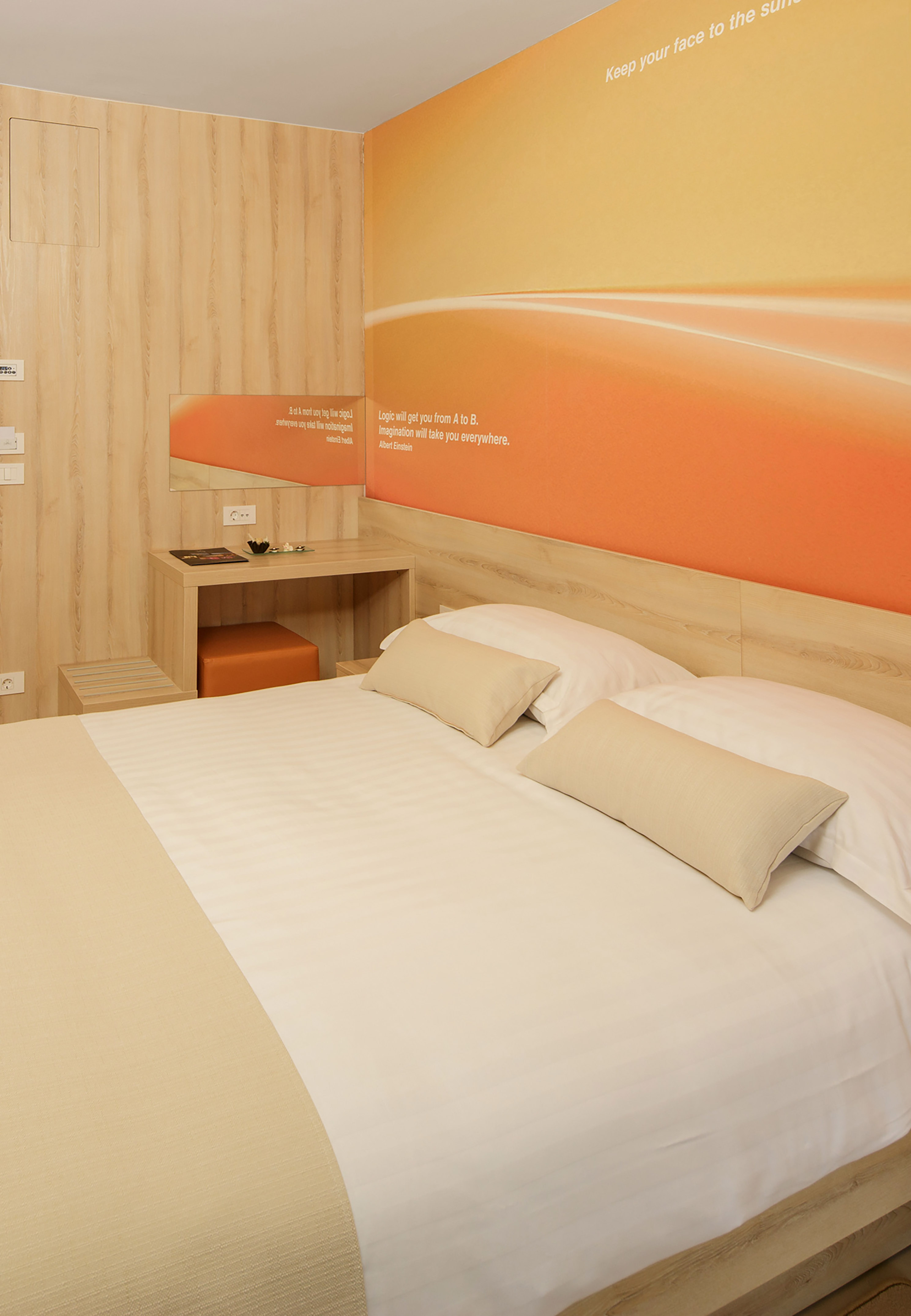 a bed with pillows and a table in a room