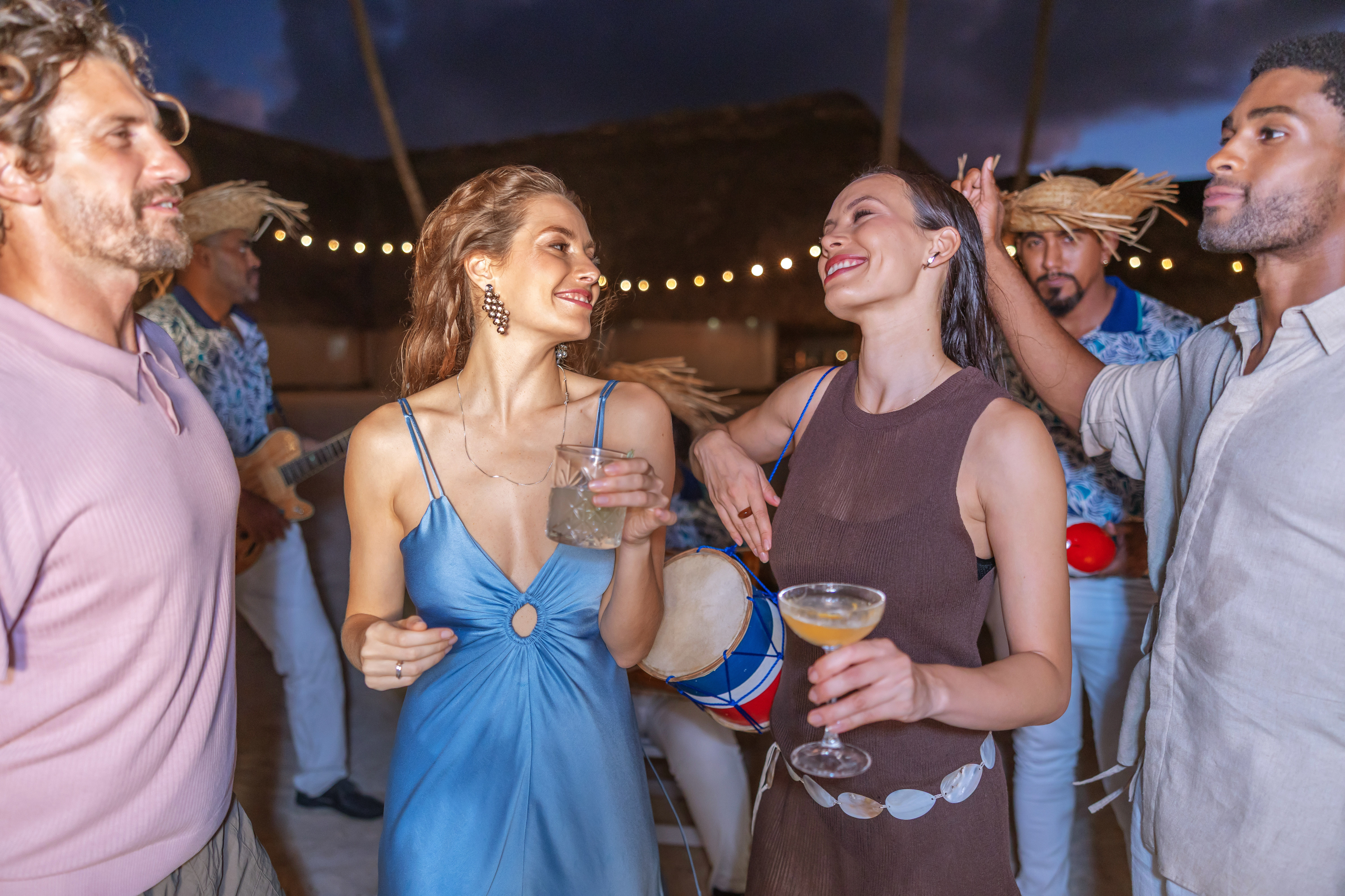 a group of people dancing and drinking