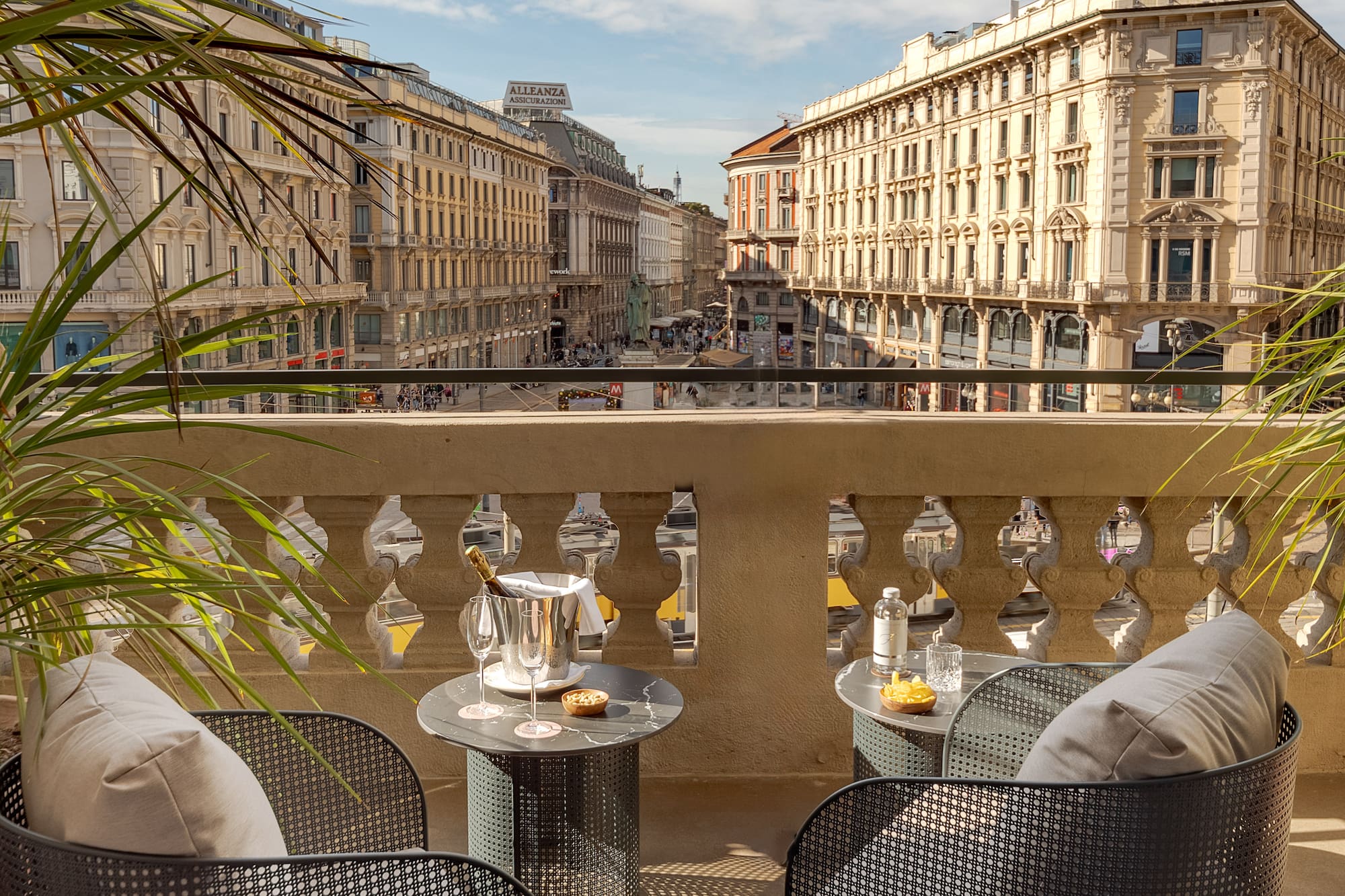 a table and chairs on a balcony with a view of a city