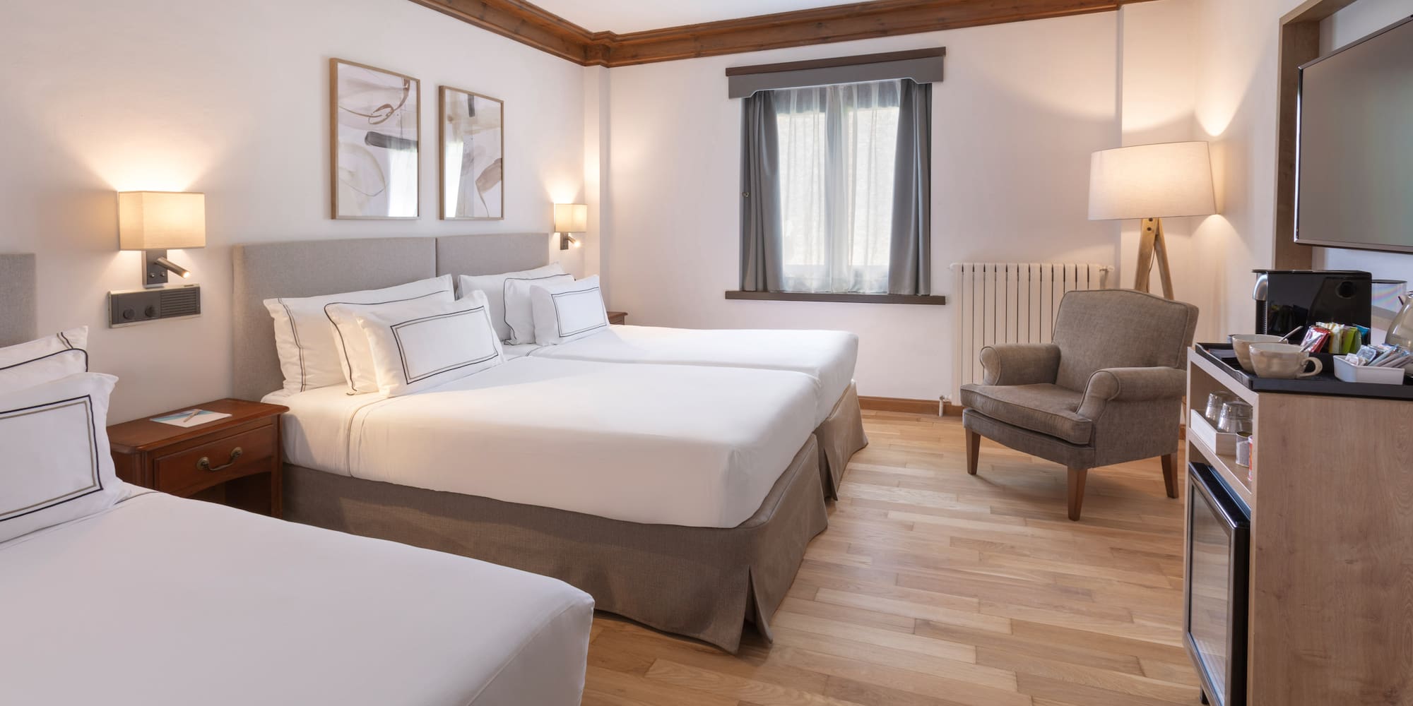 a room with two beds and a chair