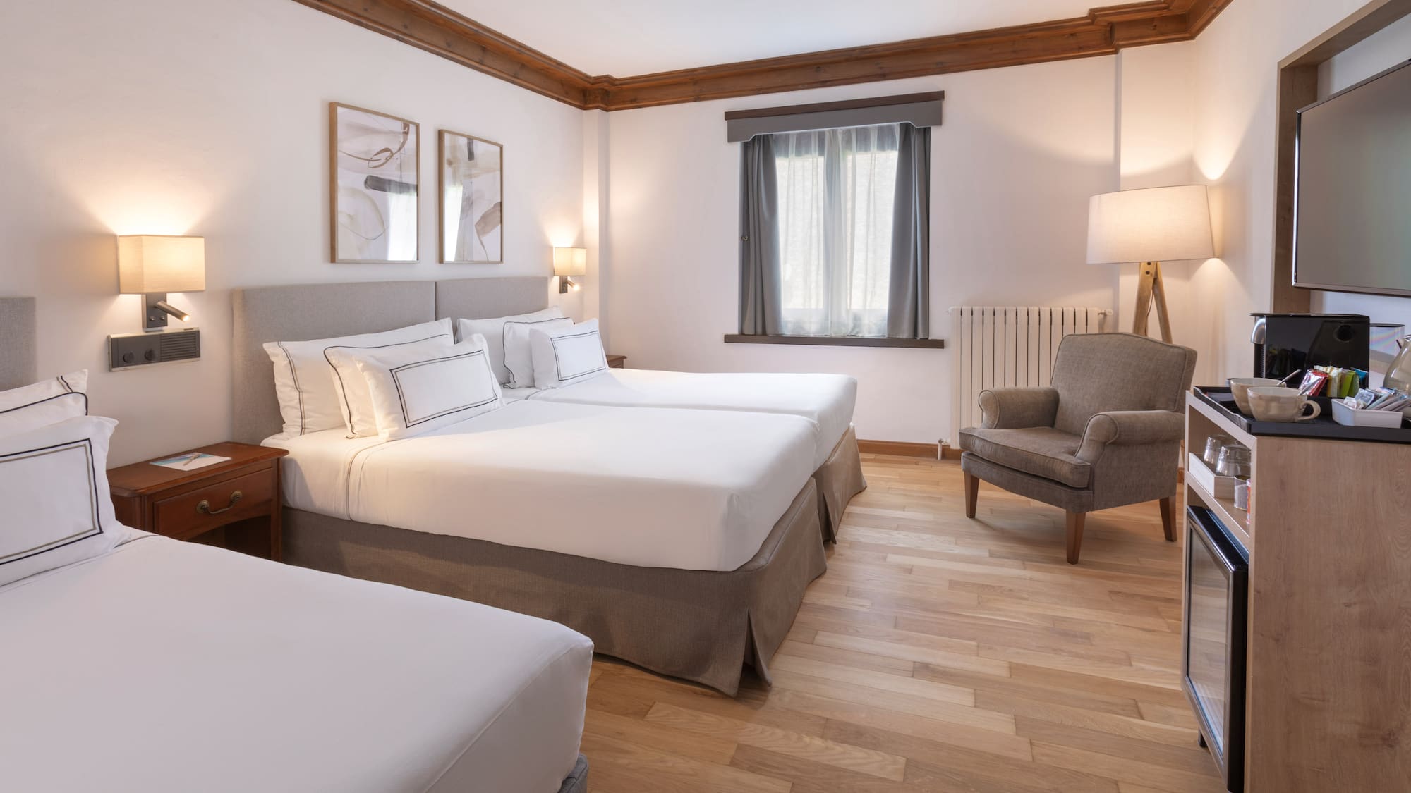 a room with two beds and a chair