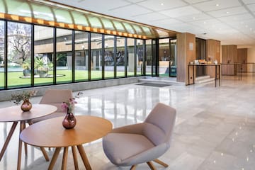 a room with a glass wall and a table and chairs