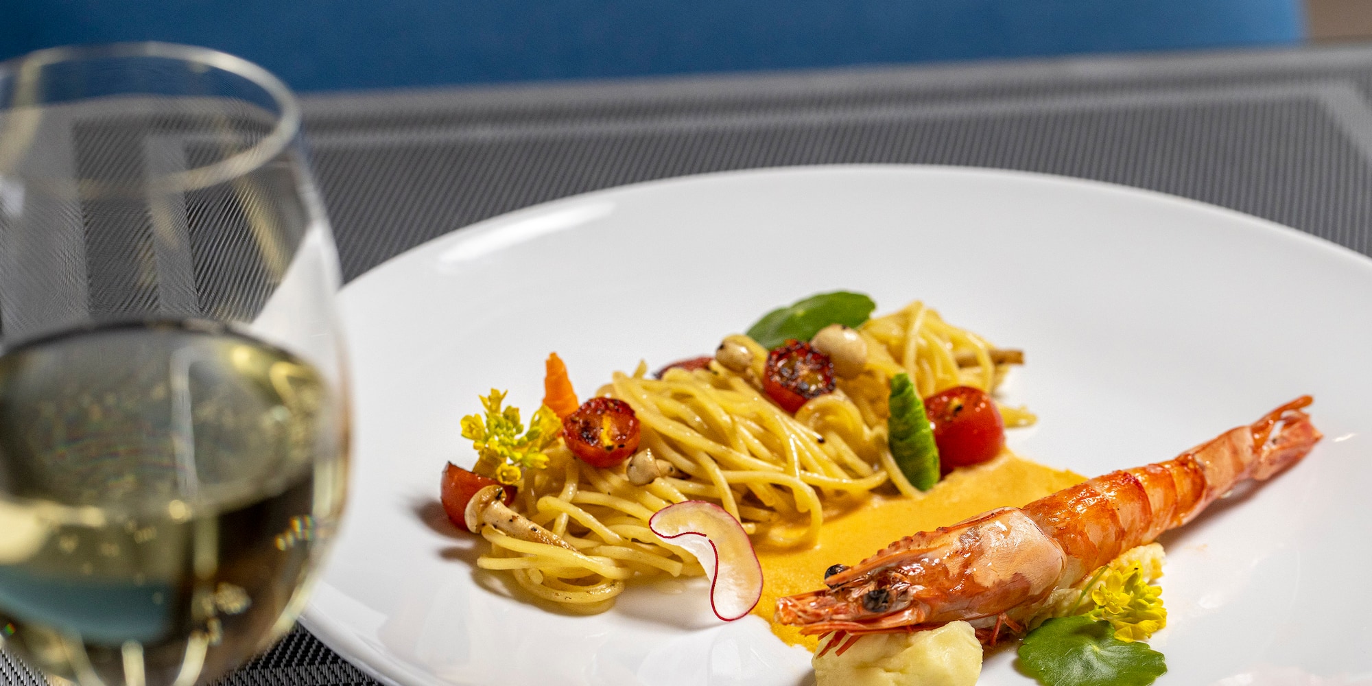 a plate of food and a glass of wine