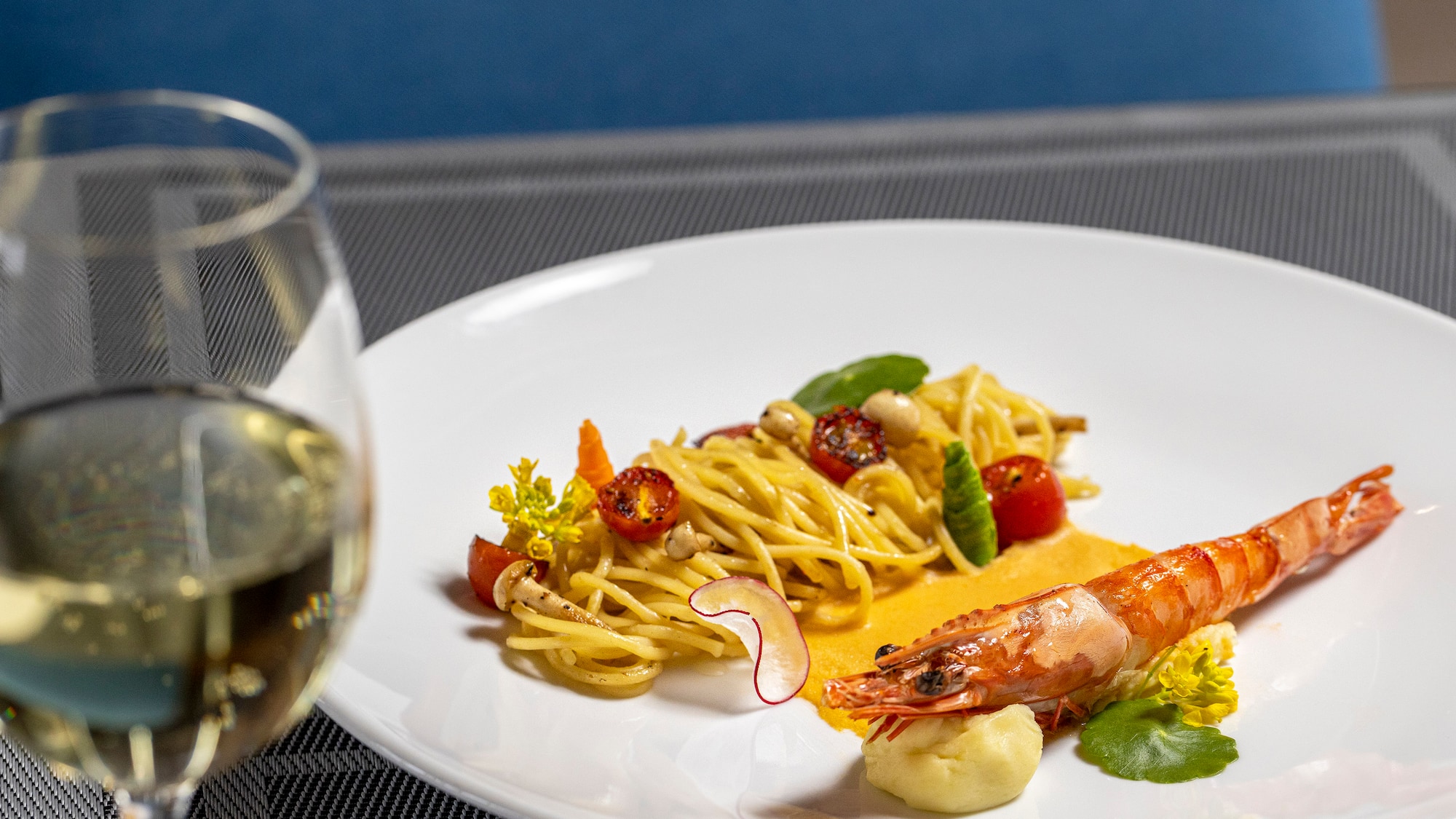 a plate of food and a glass of wine