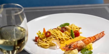 a plate of food and a glass of wine