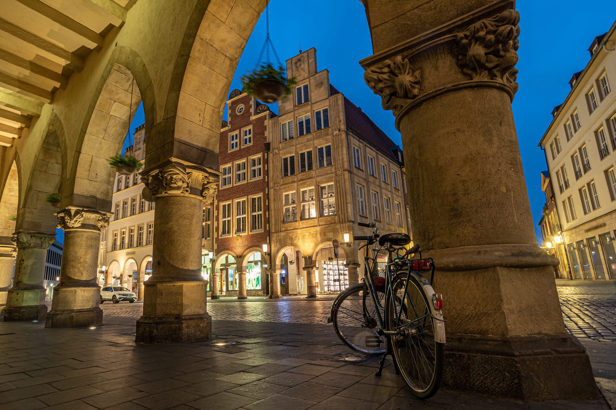 a bicycle parked on a sidewalk in front of a building