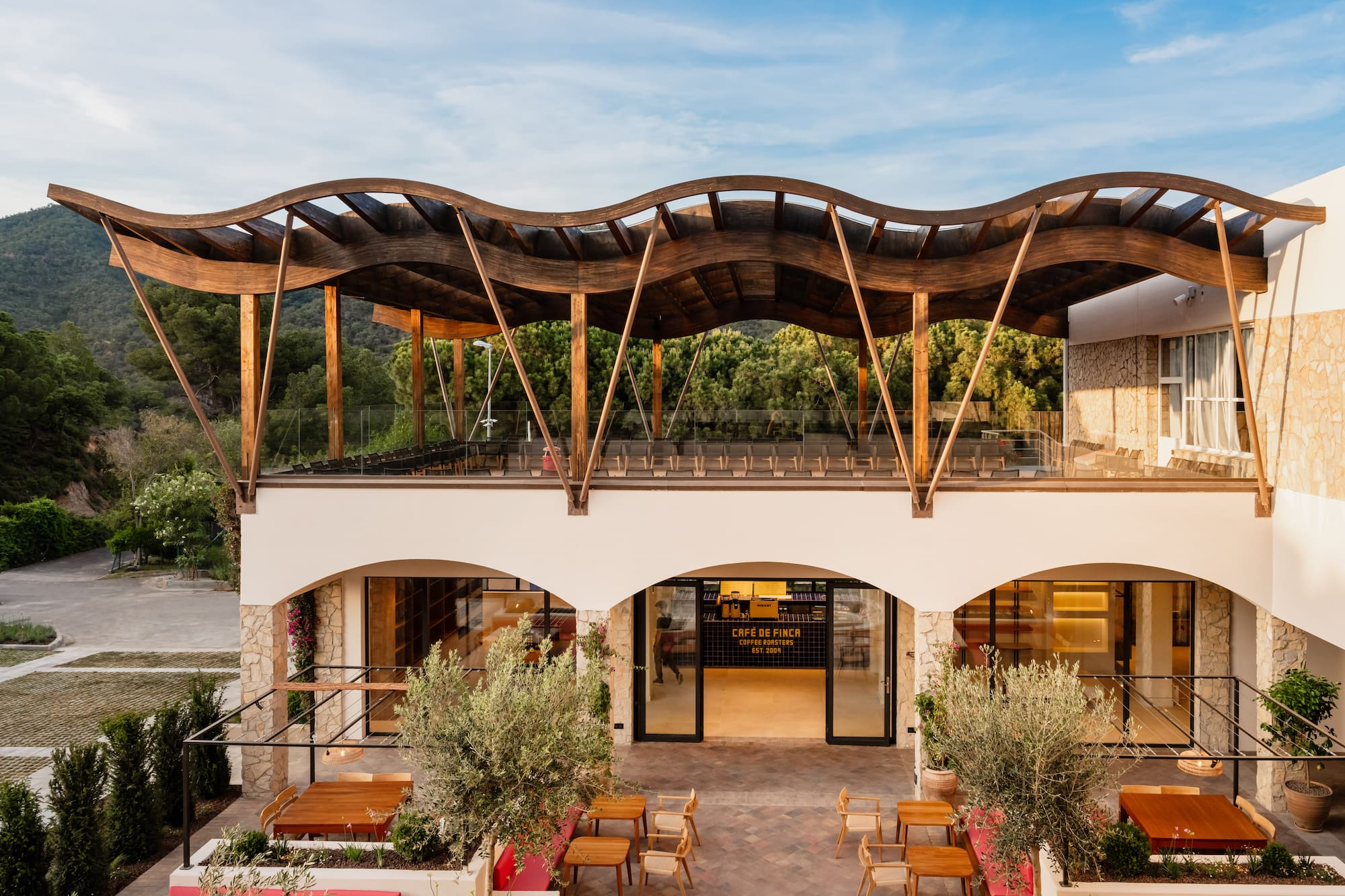 a building with a roof and chairs