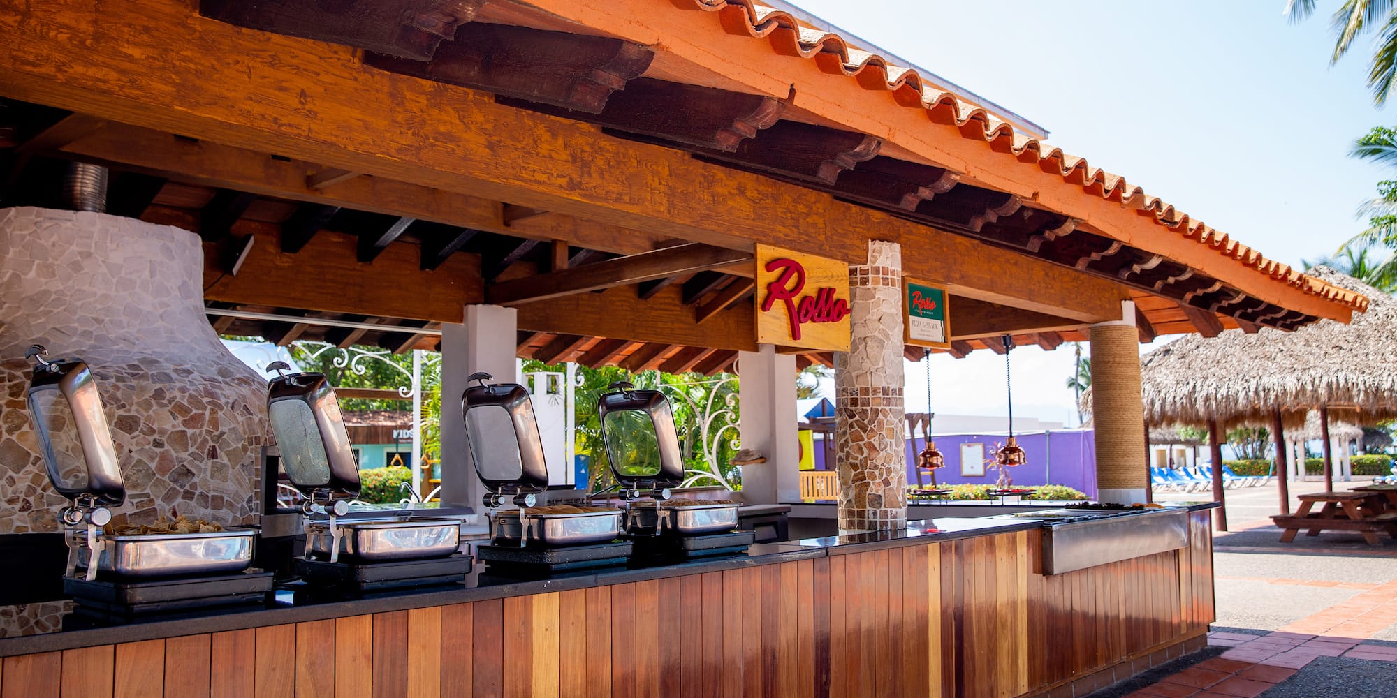 a restaurant with a row of food stations