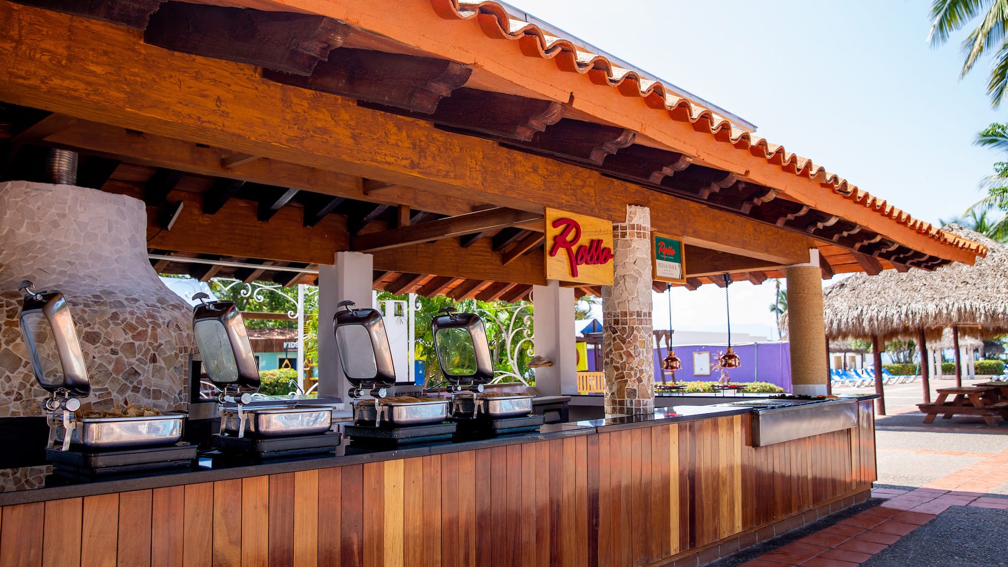 a restaurant with a row of food stations