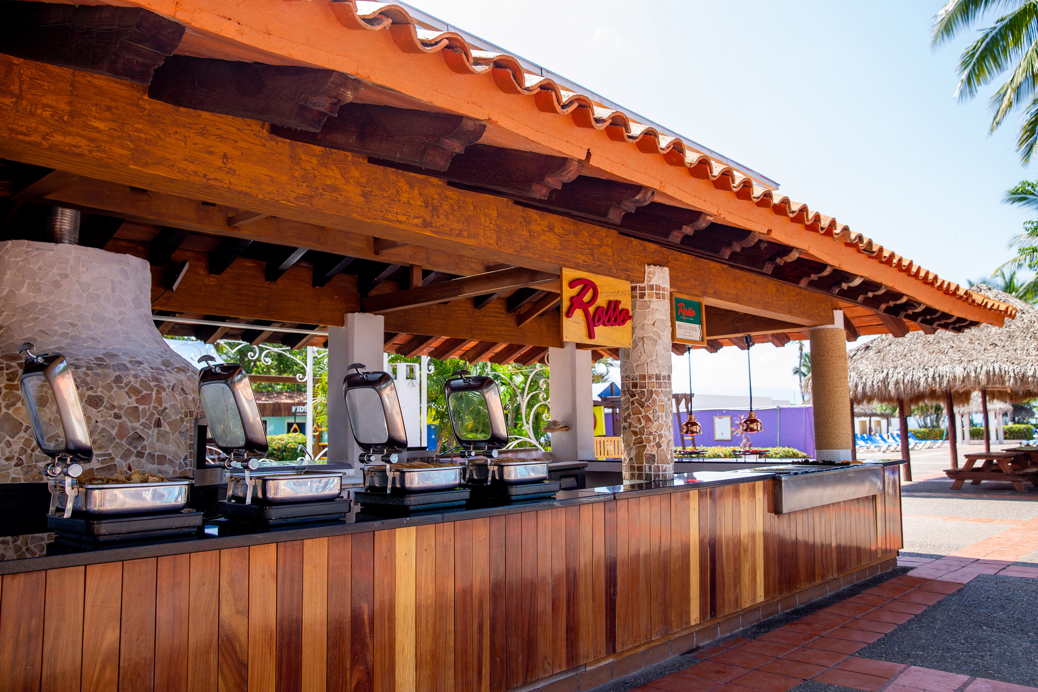 a restaurant with a row of food stations