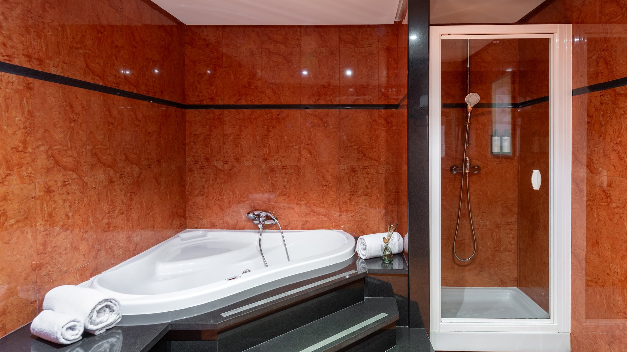 a bathroom with a bathtub and shower