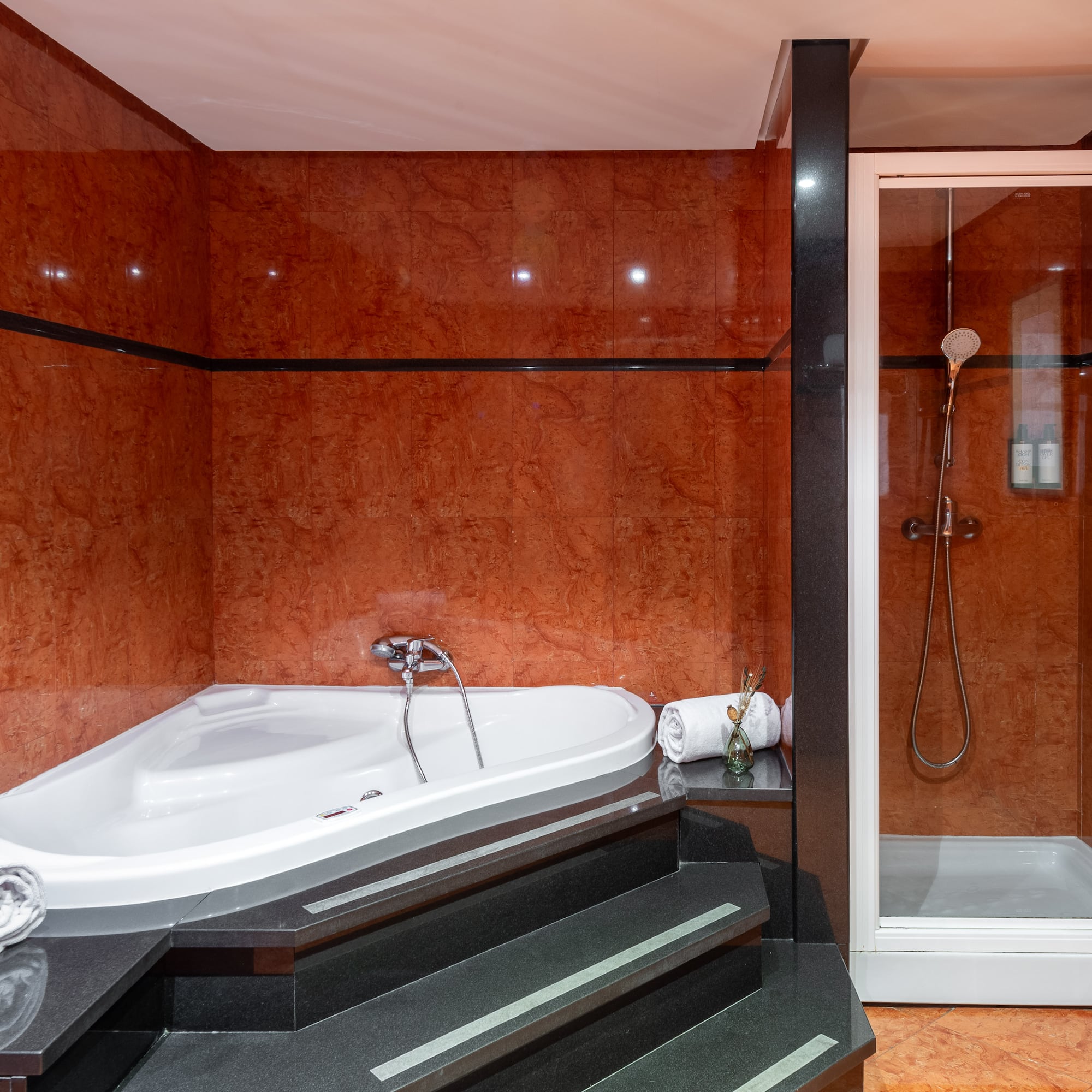 a bathroom with a bathtub and shower