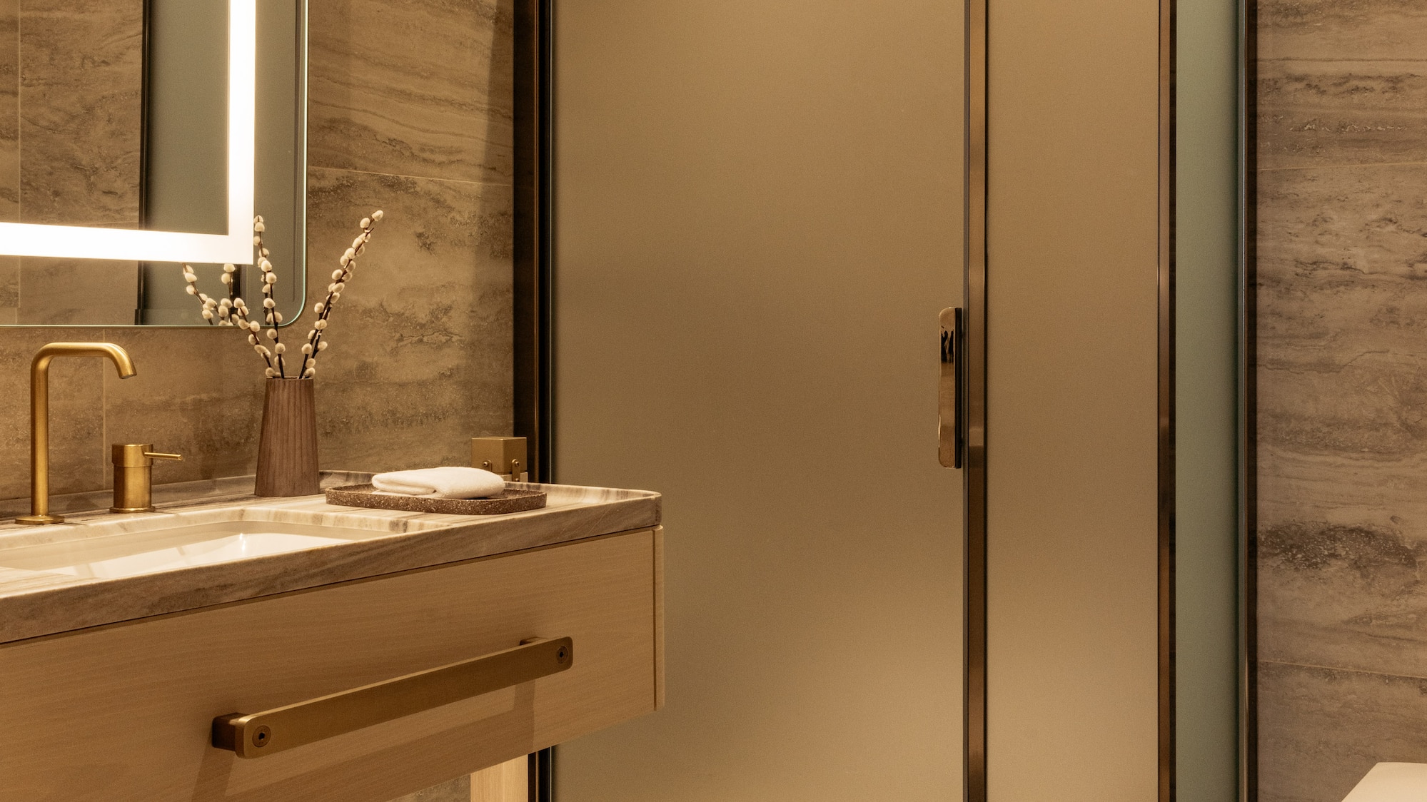 a bathroom with a glass shower and sink