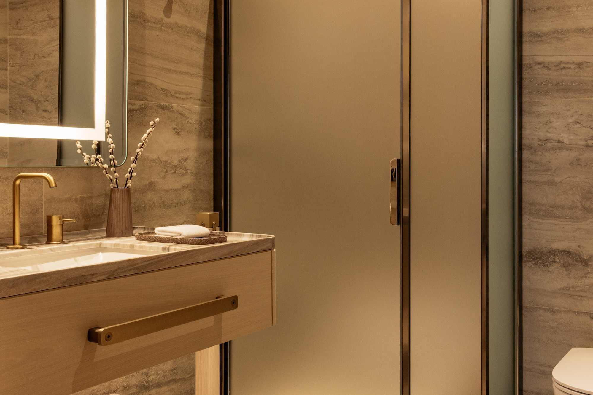 a bathroom with a glass shower and sink
