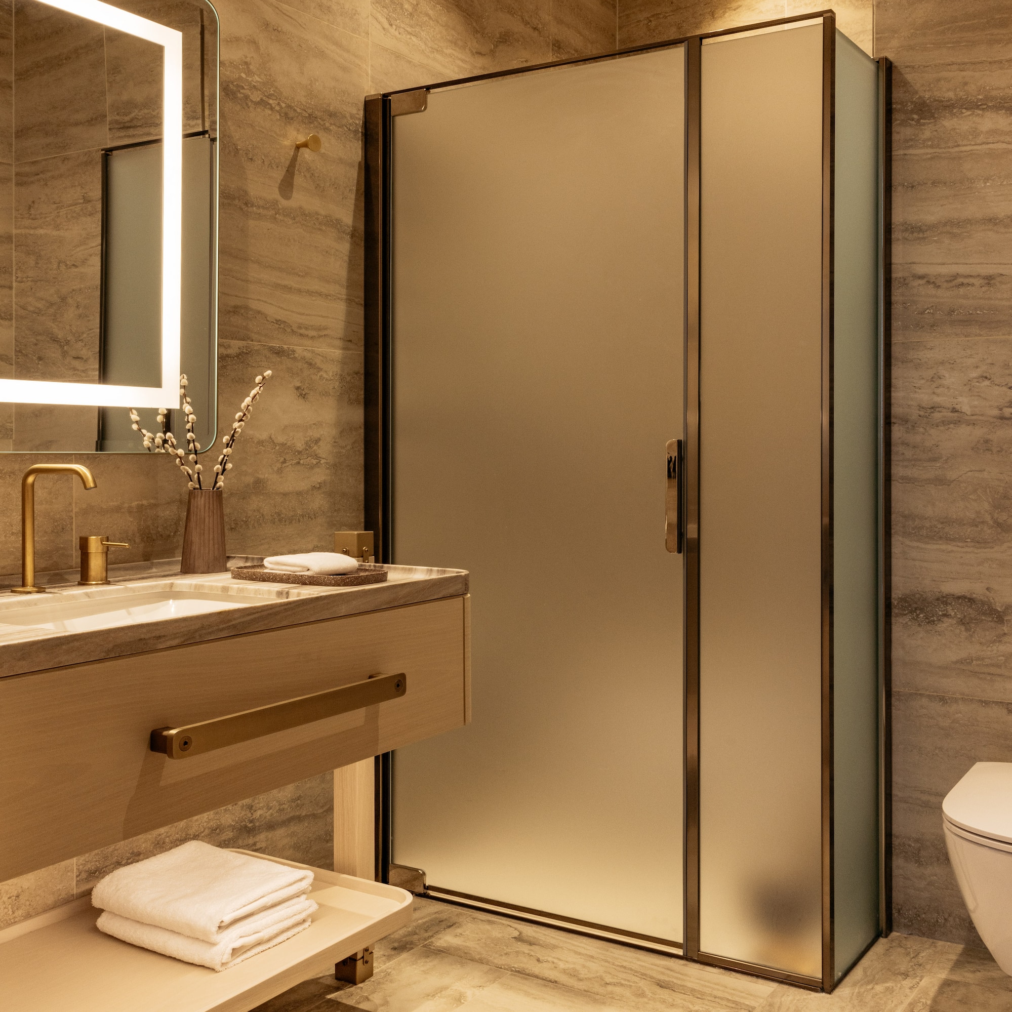 a bathroom with a glass shower and sink