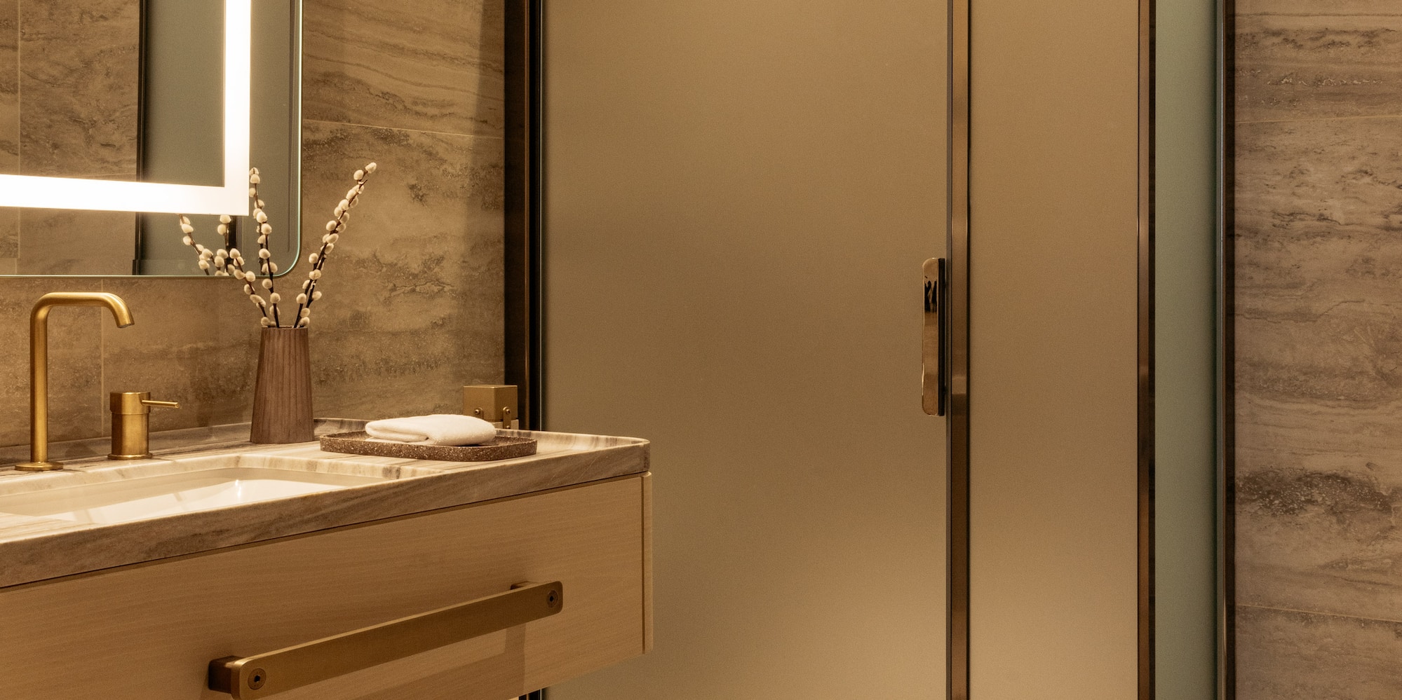 a bathroom with a glass shower and sink
