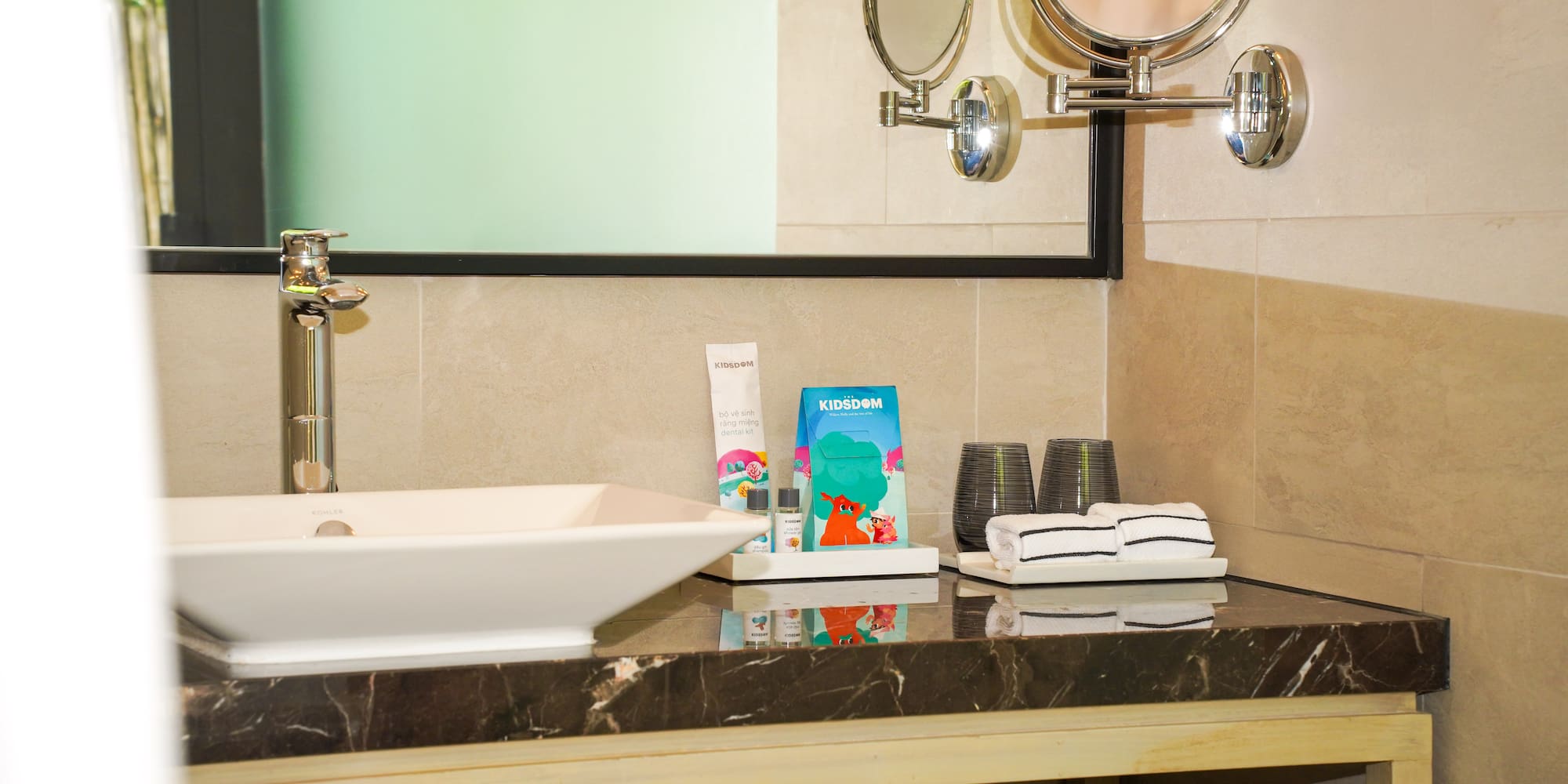 a bathroom sink with towels and a mirror