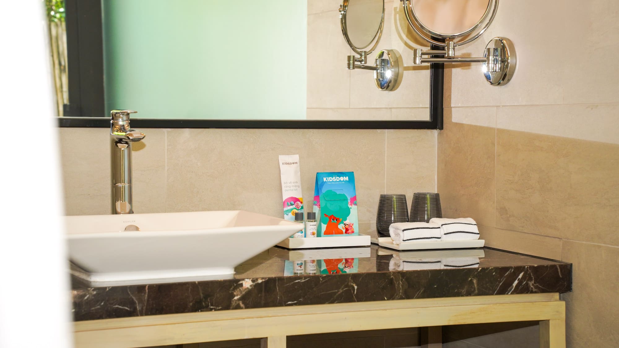 a bathroom sink with towels and a mirror