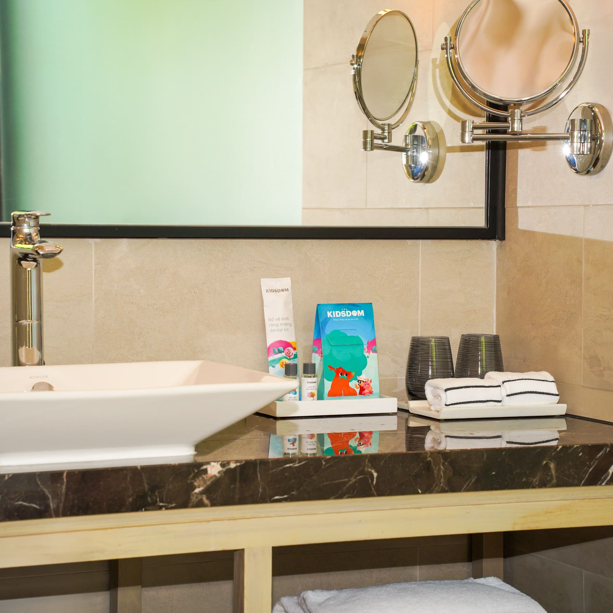 a bathroom sink with towels and a mirror