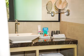 a bathroom sink with towels and a mirror