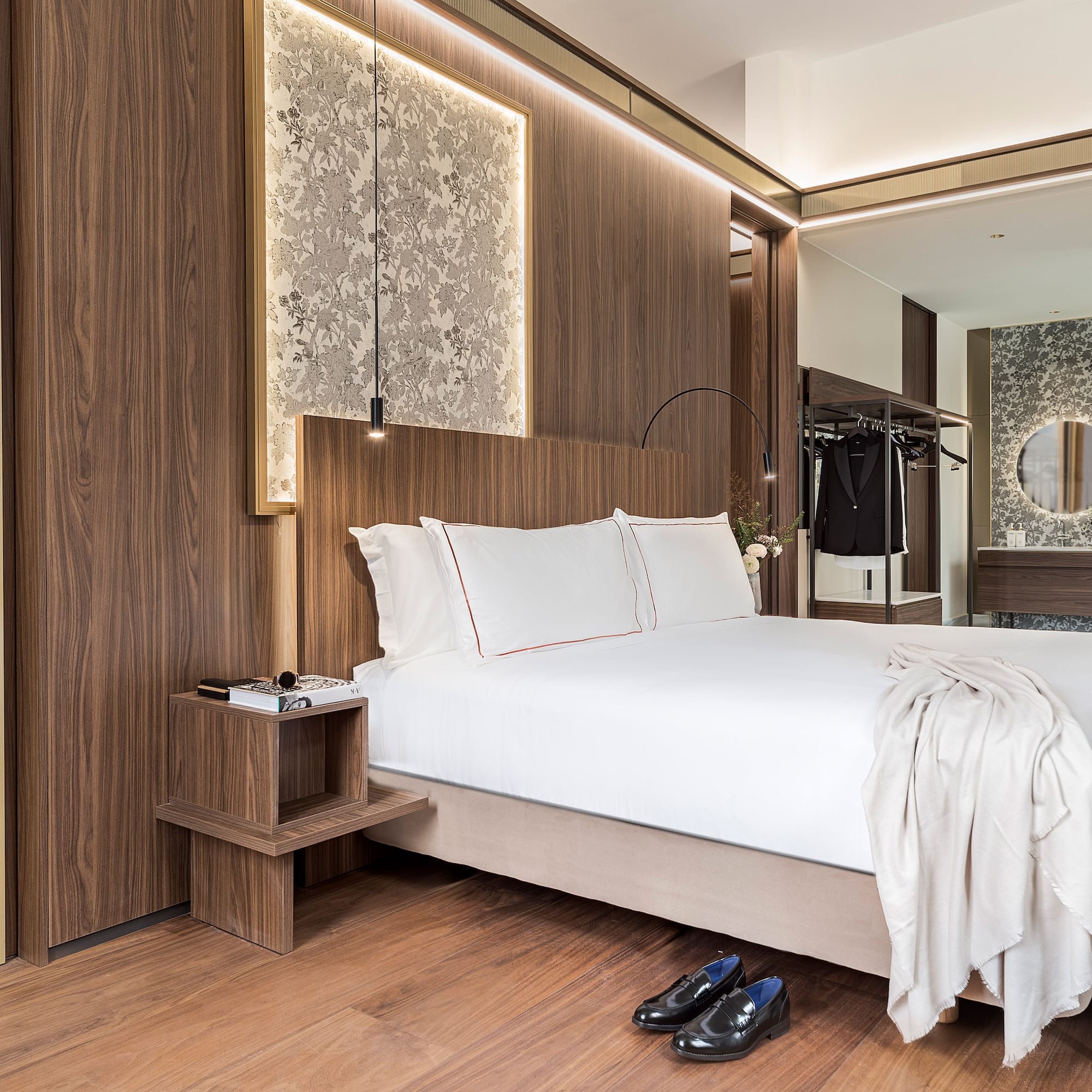 a bedroom with a bed and shoes on the floor