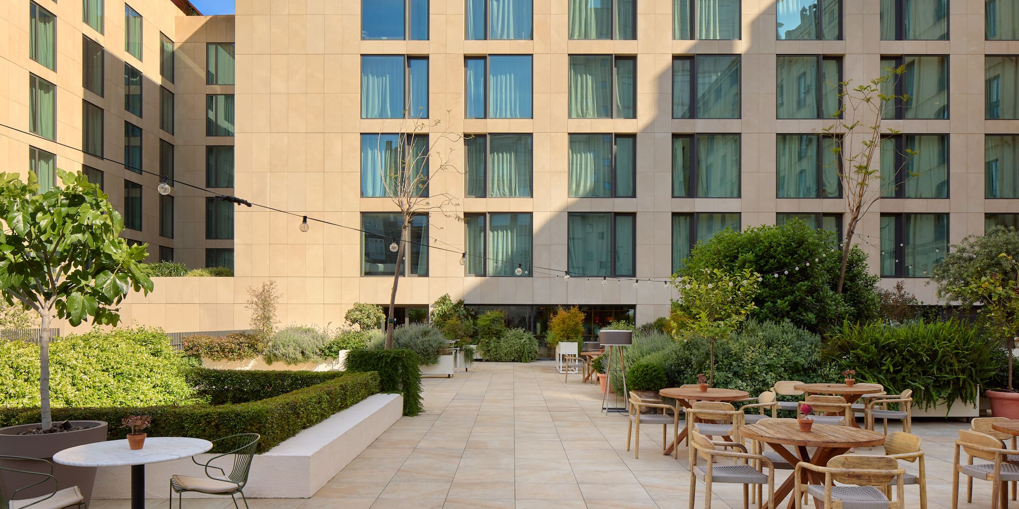 a patio with tables and chairs outside of a building