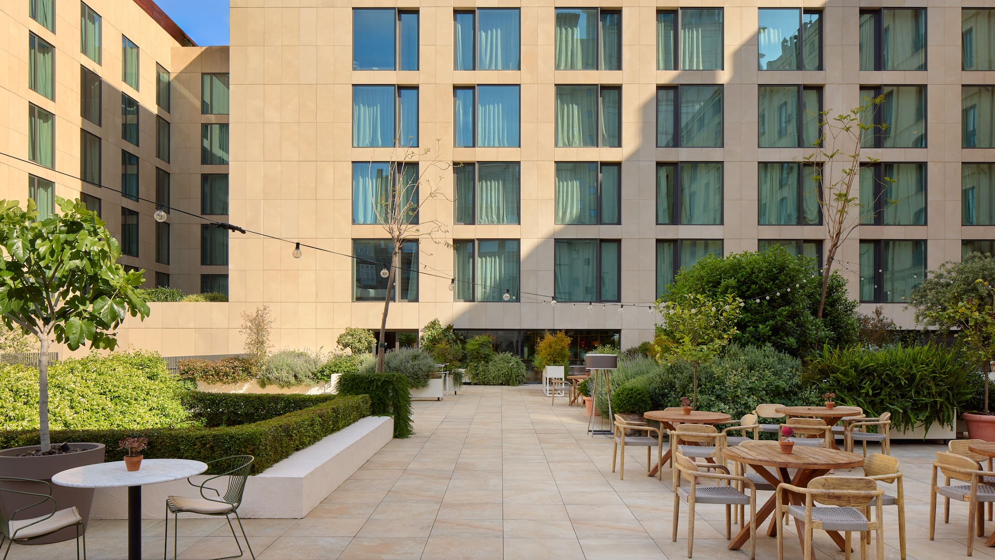 a patio with tables and chairs outside of a building