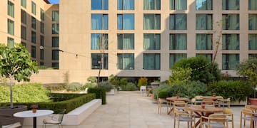 a patio with tables and chairs outside of a building
