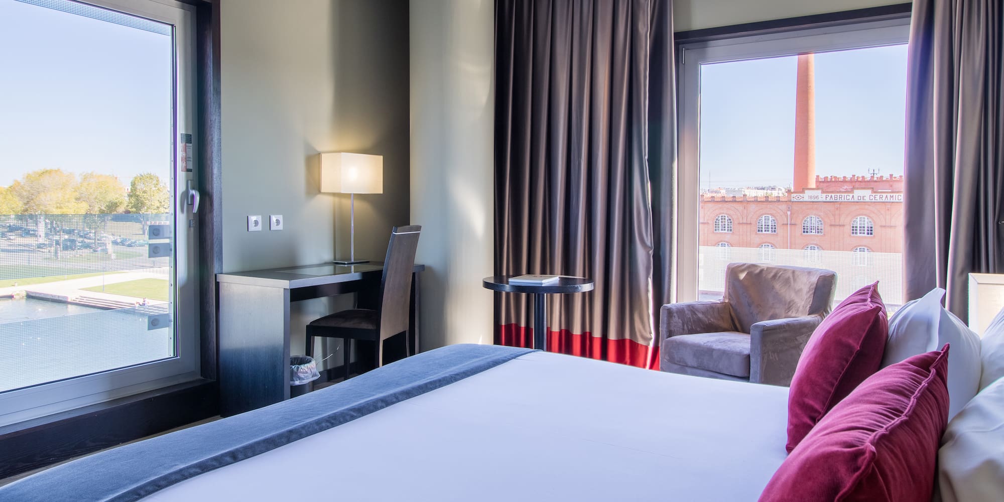 a room with a bed and a chair and a table