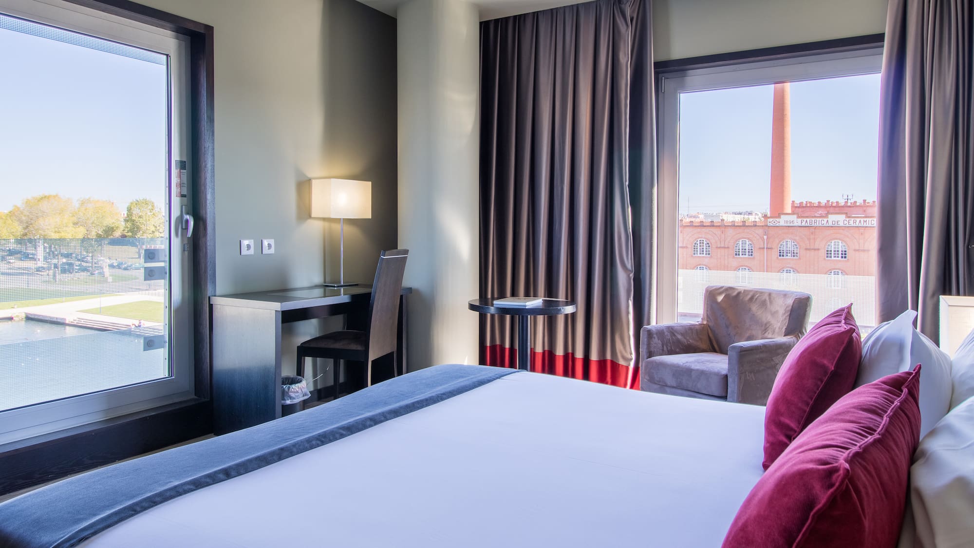 a room with a bed and a chair and a table
