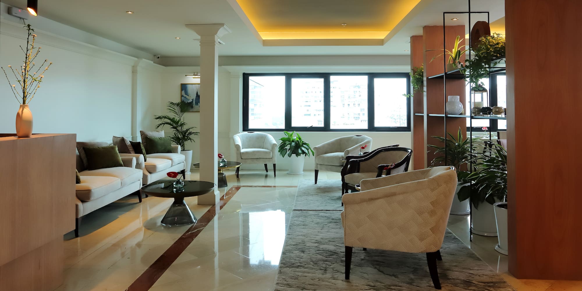 a room with white furniture and plants
