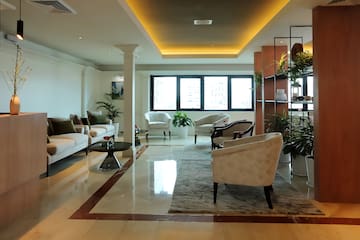 a room with white furniture and plants