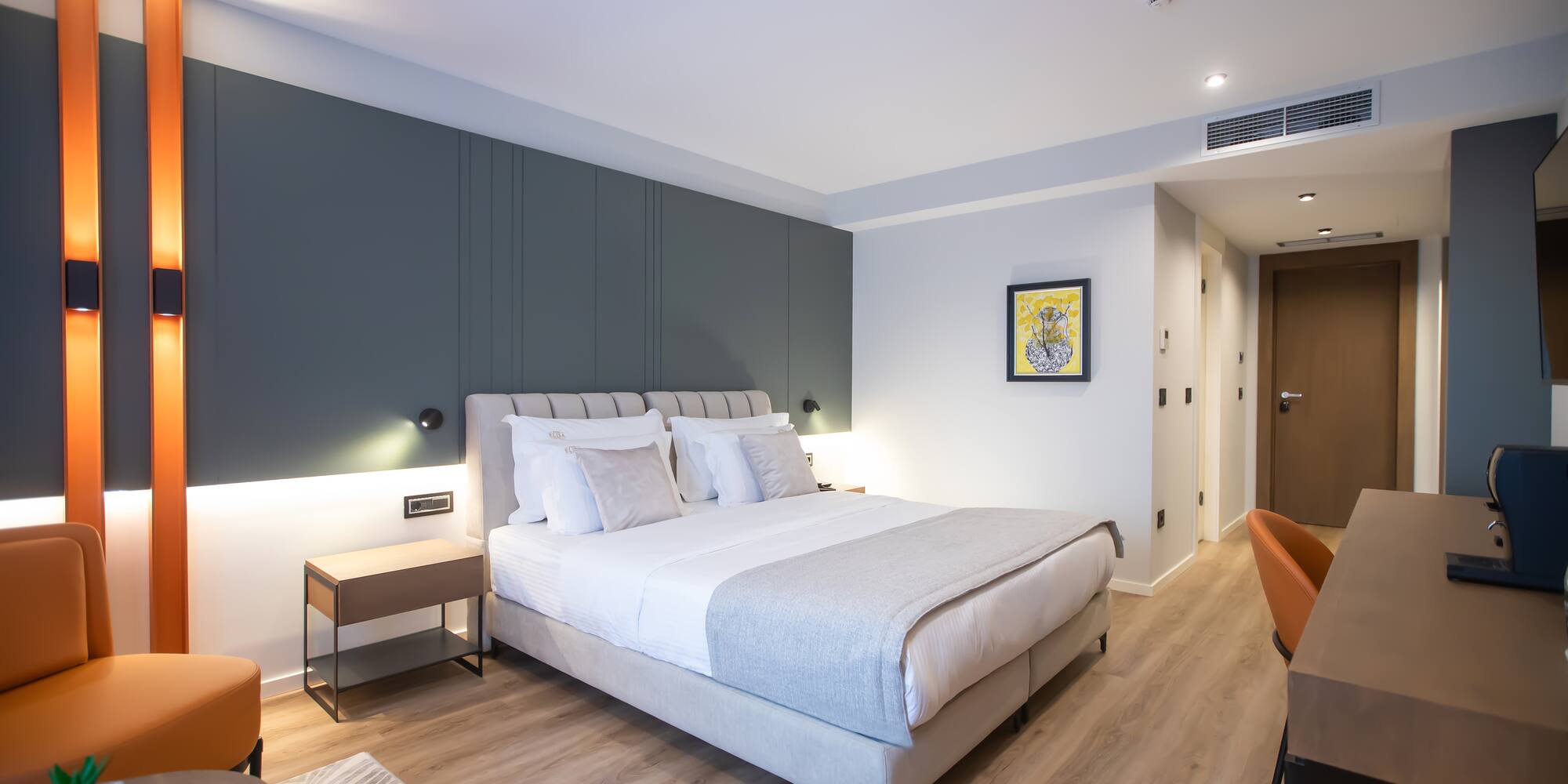 a bedroom with a bed and a wood floor