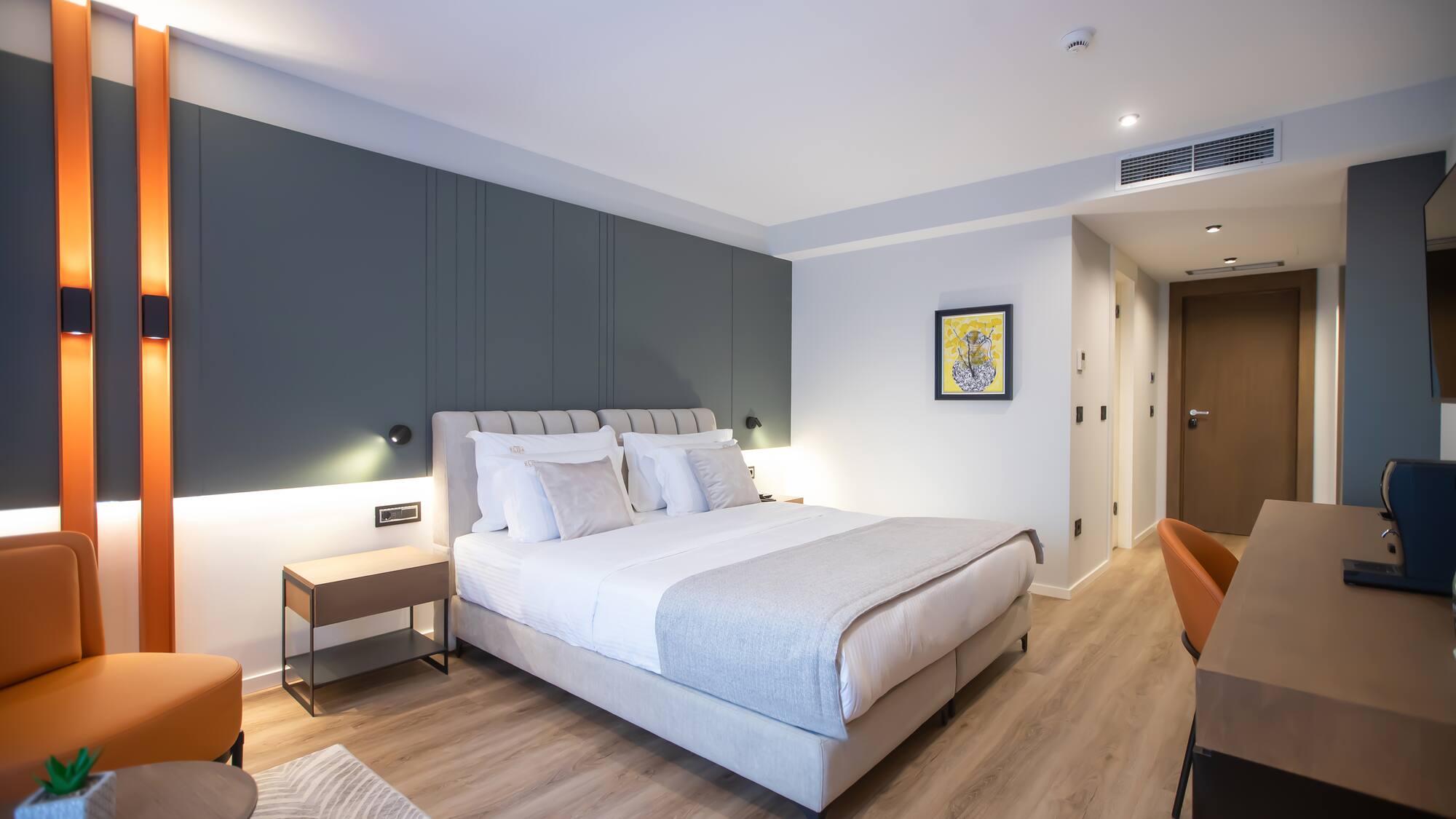 a bedroom with a bed and a wood floor