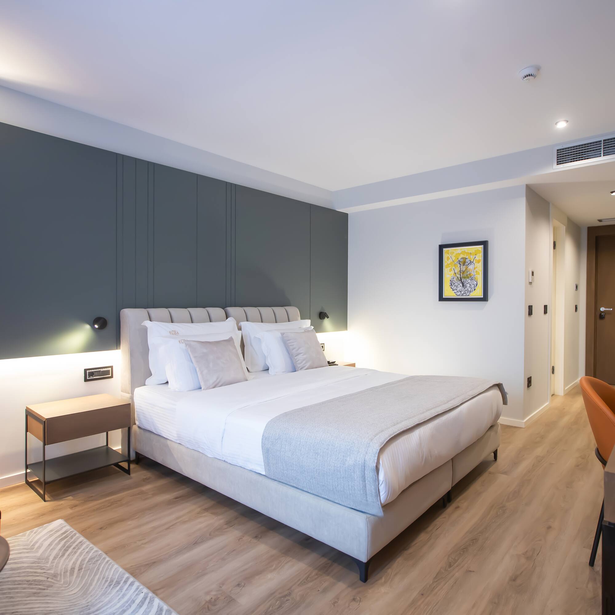 a bedroom with a bed and a wood floor