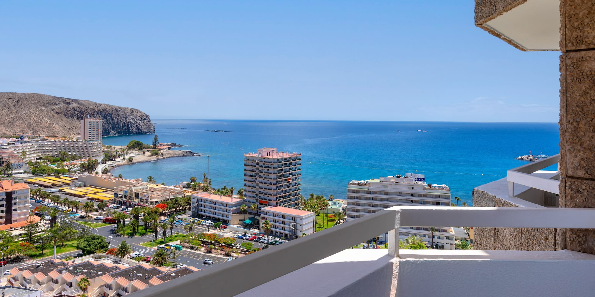 a balcony overlooking a city and the ocean