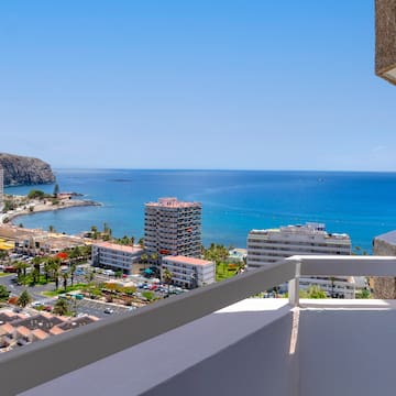 a balcony overlooking a city and the ocean
