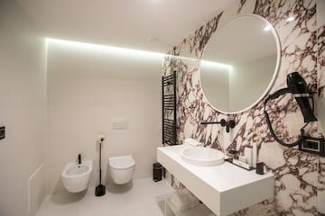 a bathroom with a round mirror and a sink