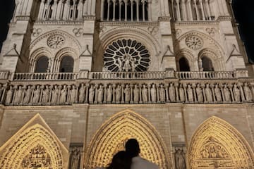a man and woman standing in front of a large building